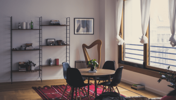 A loft apartment with a red rug.