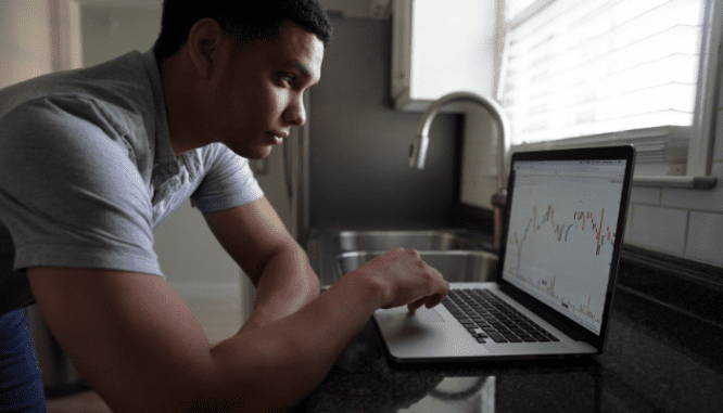 A man calculating his budget for purchasing a home in Calabasas.