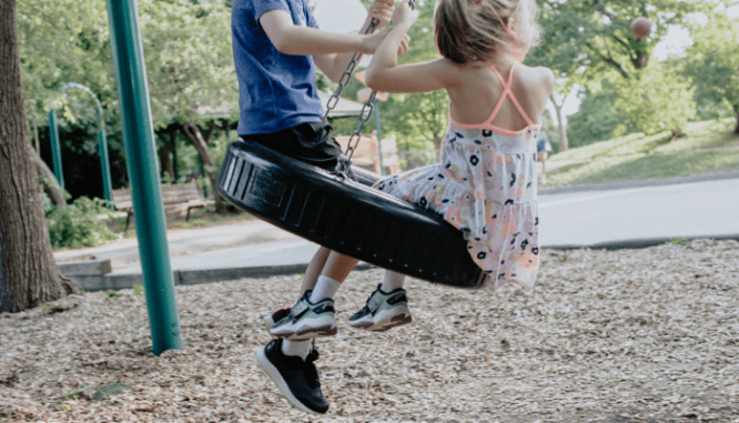 Kids swinging on a tire swing while their parents decide whether to buy a house in Madison.