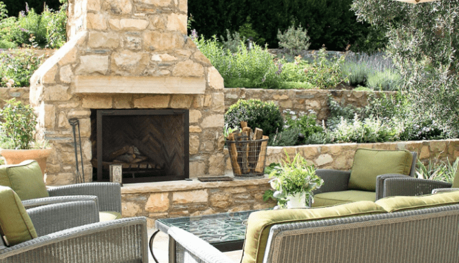 An outdoor kitchen with a fireplace.