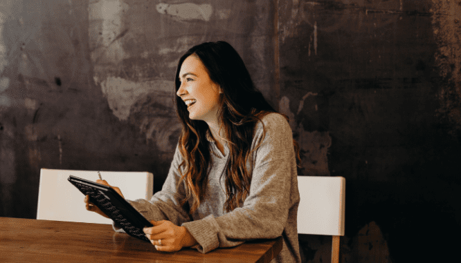An image of a happy woman to demonstrate the process of selling in a seller's market.