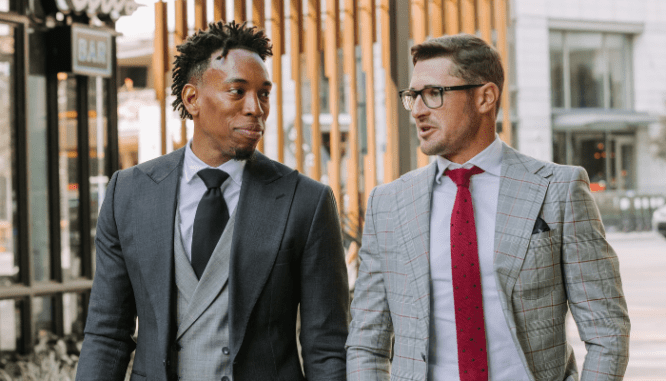 Two men discussing problematic racial issues in real estate.