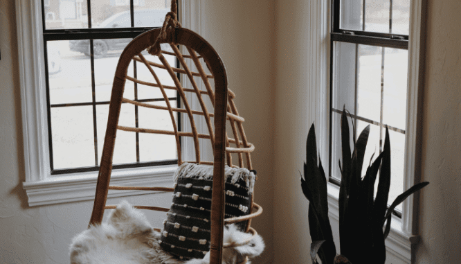 An image of a chair by a window to demonstrate the process of home window replacement.