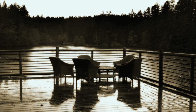 An image of a deck overlooking a lake to demonstrate how to clean a deck before staining.