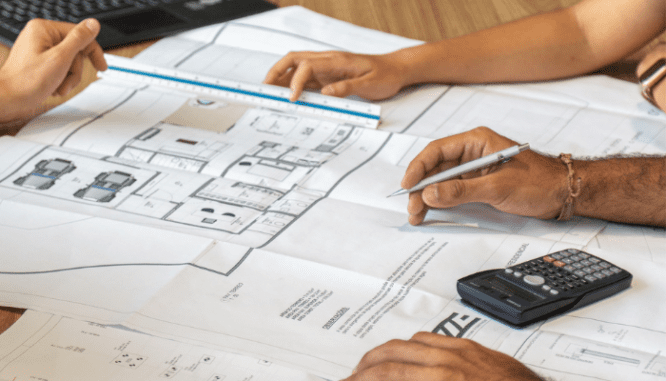 Architects draft blueprints for a home addition, a cost to consider when deciding whether to add on or move.