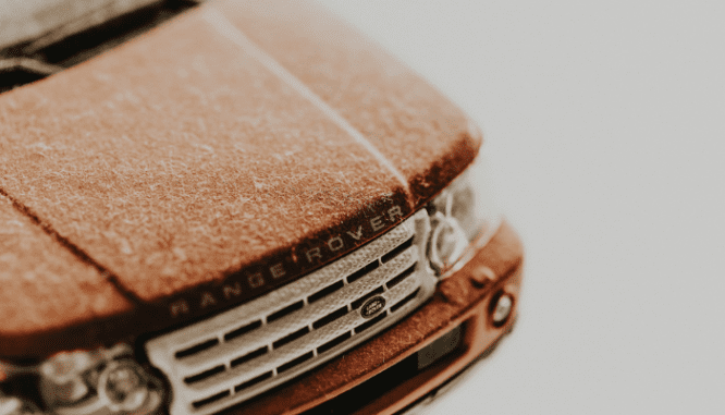 A toy car with dust and dust mites in the house.