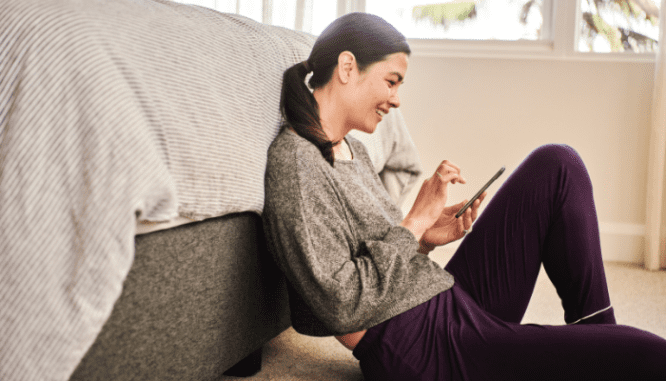A woman signing an offer on a new construction home.