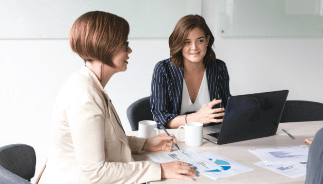 An image of two people talking to demonstrate the next housing recession.