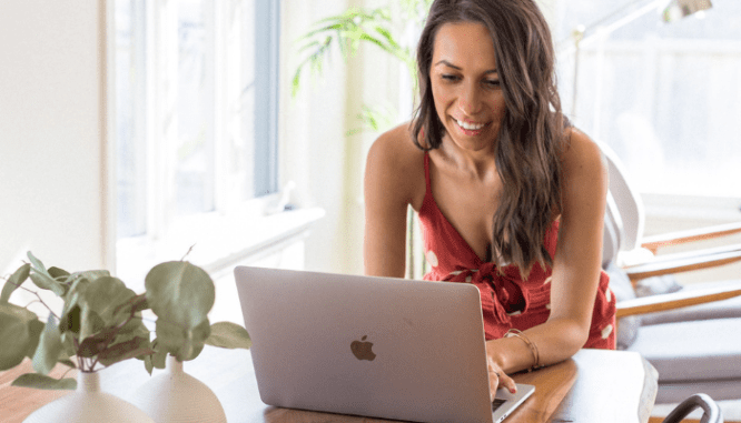 A woman uses a laptop to look up online appraisals.