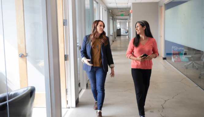Two people walking to their home closing, which may be conducted by the seller's agent.