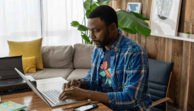 A person researching the housing market online, which is an important thing to do when going to open houses.