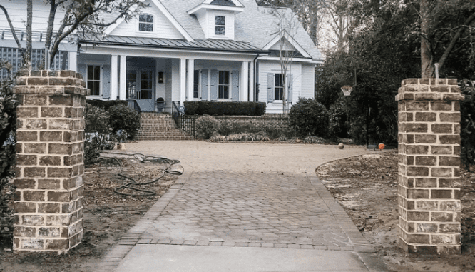 Brick columns outside of a home with landscaping.