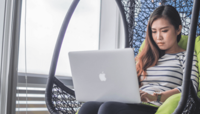 A woman looking online to see if she should pay off her home or invest.