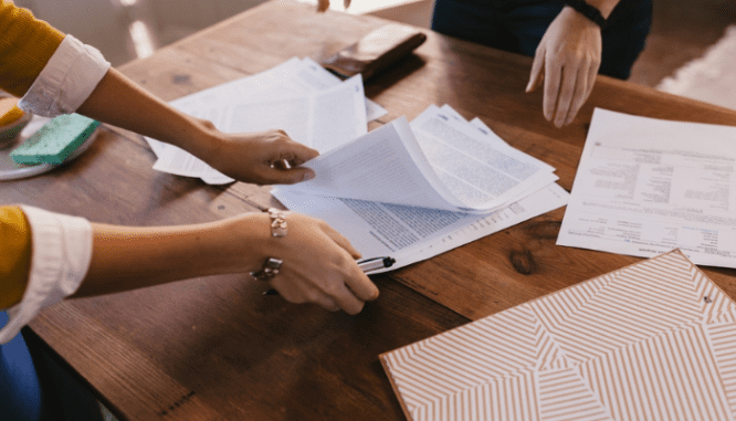 People reviewing paperwork for an as-is home sale.