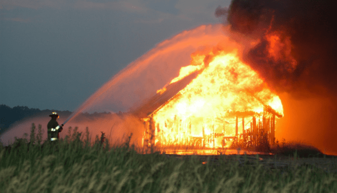 A house on fire that is protected by home insurance.