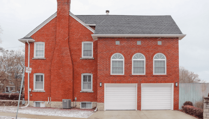 A house with new garage doors that's one of the many exterior home improvements made.
