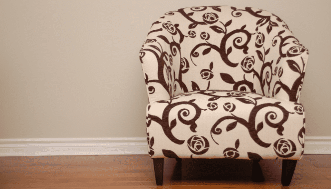 a chair beside wood trim that has had the gaps filled.