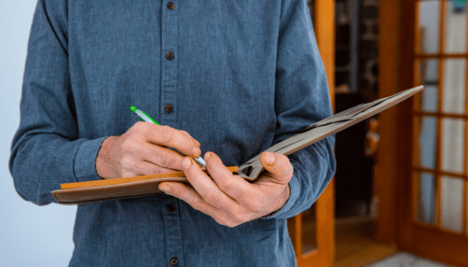 A person appraising a house, which might require an appraisal gap guarantee.