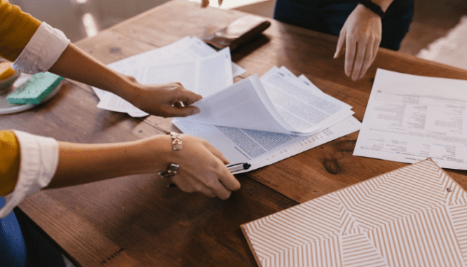 A real estate agent preparing a contract for selling a house.