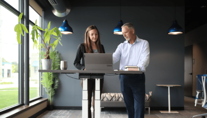 A real estate agent explaining a contract for selling a house to a homeseller.