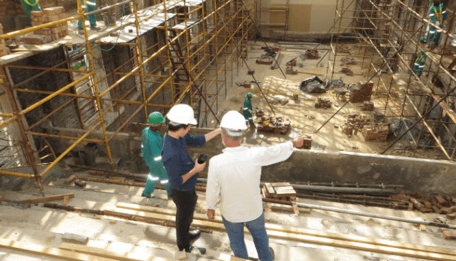 Builders working on adding a bedroom.
