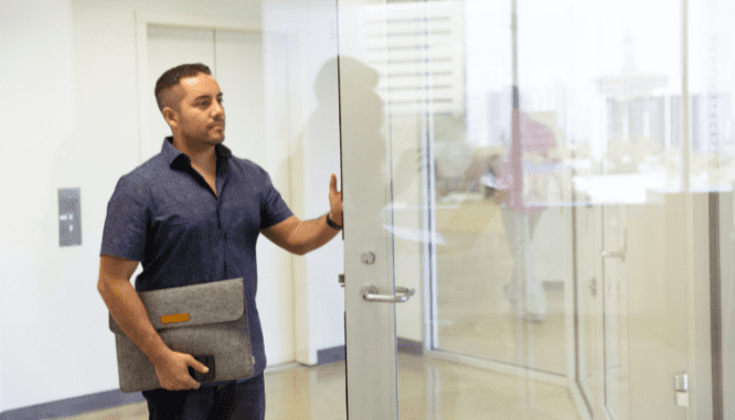 A person entering an office to discuss how to buy a preforclosure.