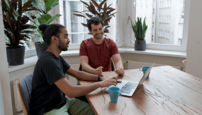 Two people talking about how to save for a house with a low income.