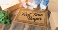 a floormat that says first time home buyer