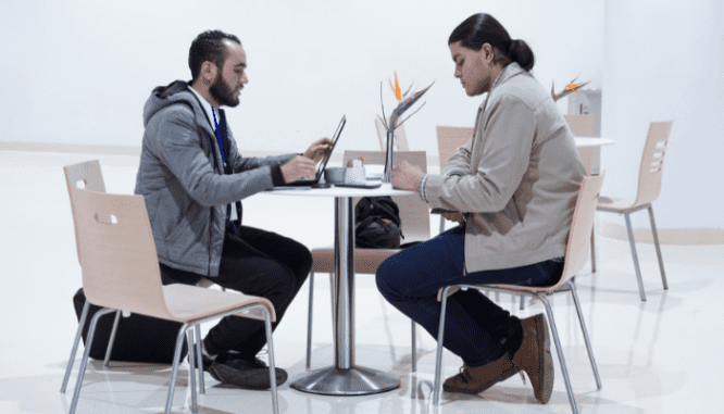 Two people discussing making sure a house is priced to sell.