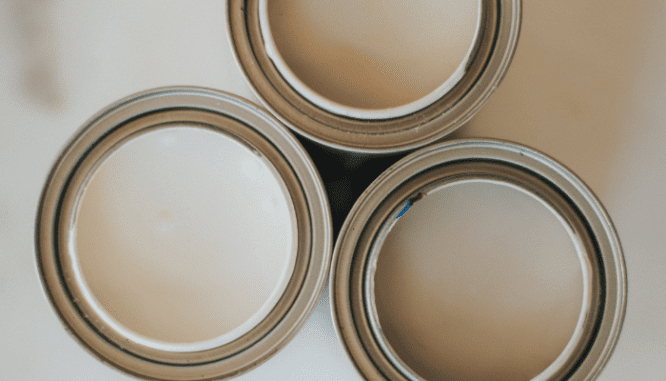 Cans of neutral colored paint, which you might want to use when remodeling before selling.