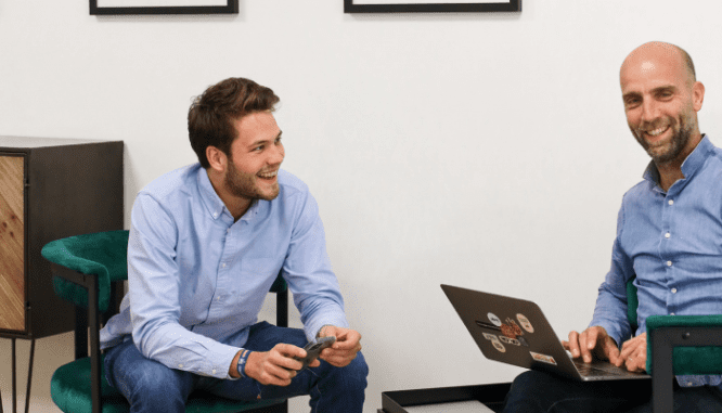 Two people discussing how to save for a house down payment.