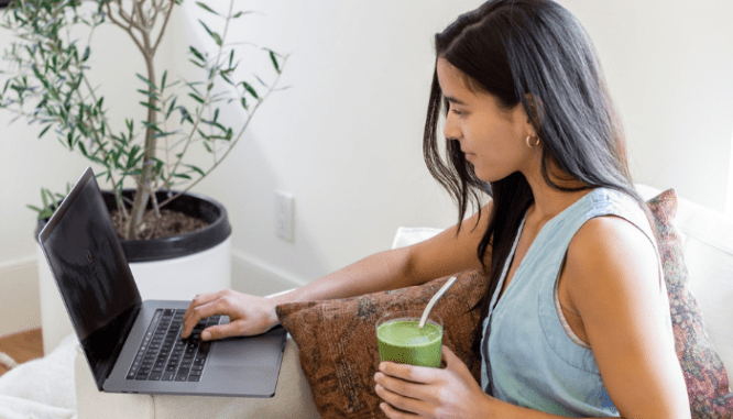 A woman using a laptop to make money in real estate.