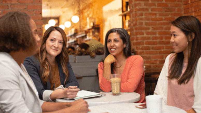 a group of women discussing the steps to closing on a house
