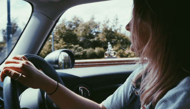 A person driving to find an open house.