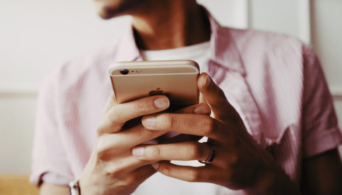 A person looking on their phone for down payment assistance in Massachusetts.