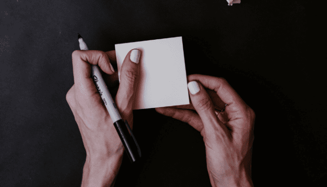 A person using a post-it to decide on down payment assistance in North Carolina.