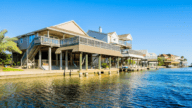 An image of a house near the ocean to demonstrate how to sell a house that has flooded.