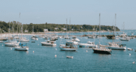 Boats near a house for sale in Massachusetts.