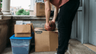 A man moving boxes to demonstrate what happens when you sell your home and rent it back.