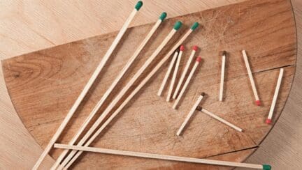 Long and short matches in bulk on a table to symbolize a short sale