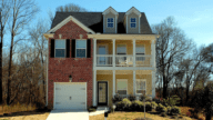 A home that is set to be sold, with the homeowner monitoring property values using a tool like Zestimate.