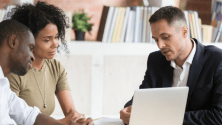 A listing agent meeting with a couple.