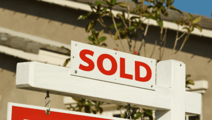 A sold sign on a house cleaned out to sell.