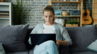 A woman on her laptop looking up how long a short sale stays on your credit.